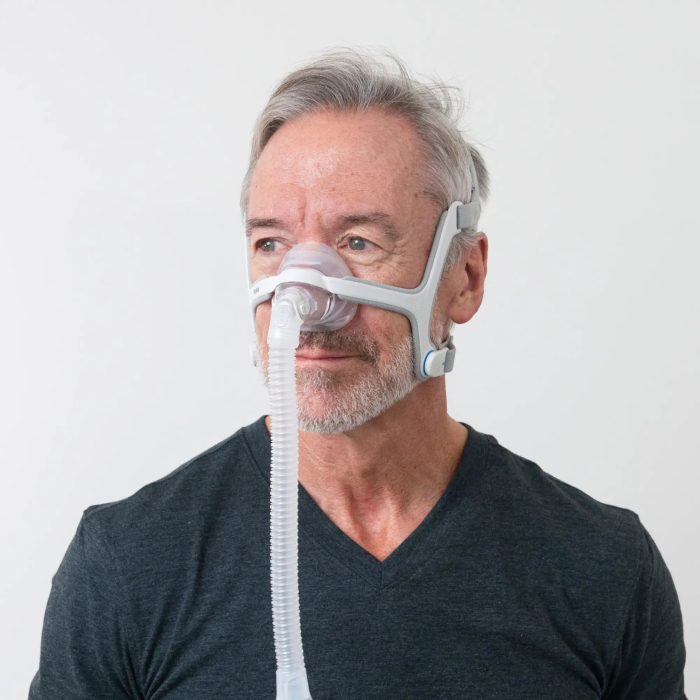 man using the resmed airfit n20 nasal cpap mask with headgear side view 3