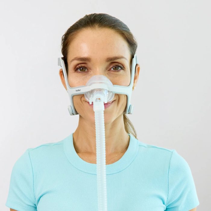 woman using the resmed airfit n20 nasal cpap mask with headgear front view 3