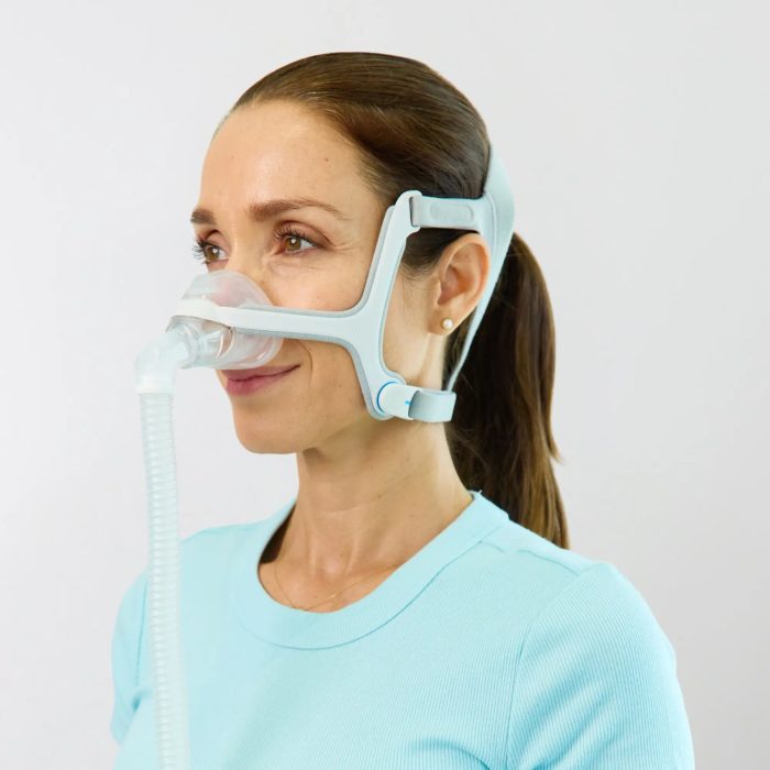 woman using the resmed airfit n20 nasal cpap mask with headgear side view 3